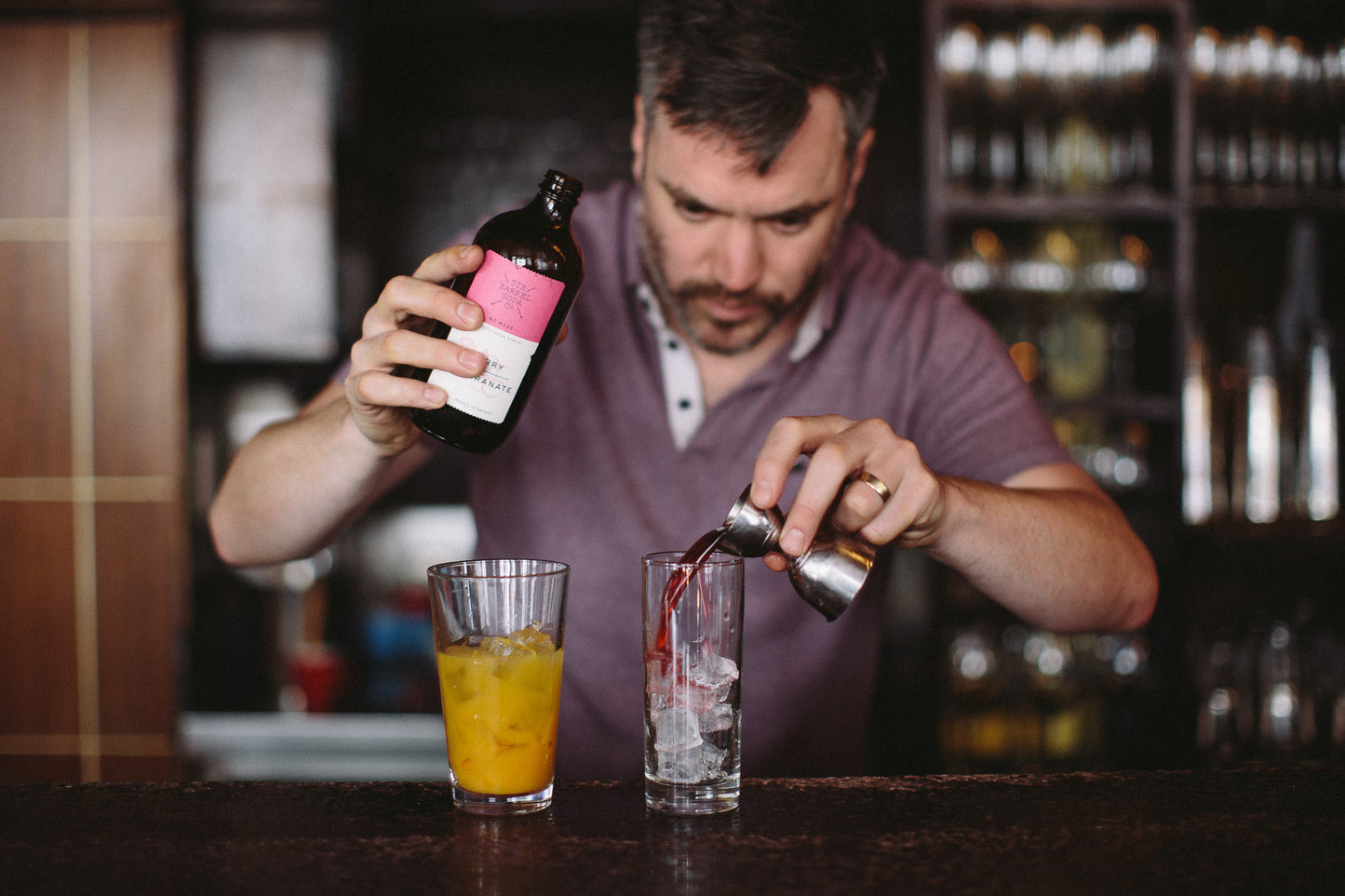 Bartender making a cocktail using Six Barrel Soda syrups
